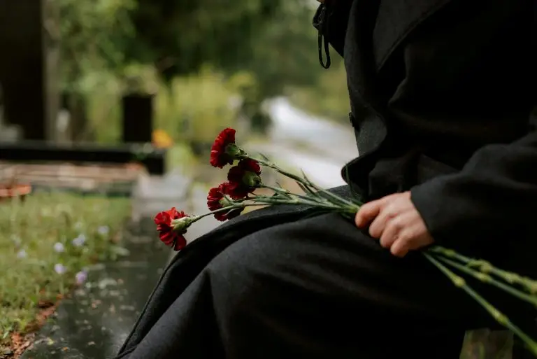 woman with flowers at a cemetery