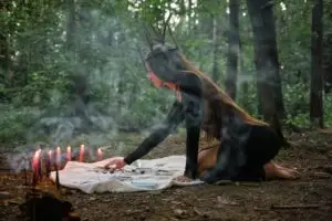 woman reading tarot cards in the woods